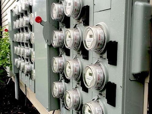 A photo of electric meters at an apartment building